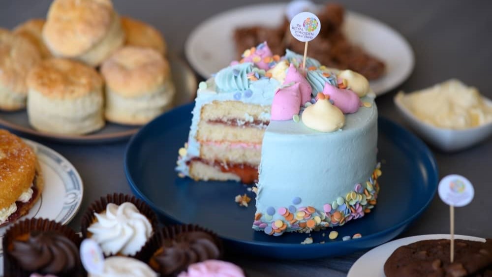 A table top of cakes at a cake sale