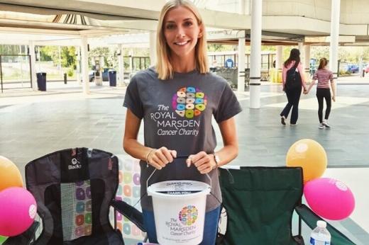 Image of a woman with a money collection bucket raising funds for the charity