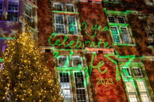 The facade of The Royal Marsden in Chelsea lit up with star lights. There is a lit up Christmas tree in front. 