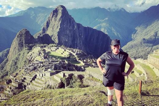 Female trekker standing in front of mountains