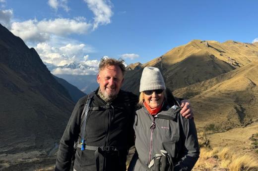 Two hikers in front of a mountain