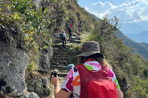 Hikers climbing mountain edge