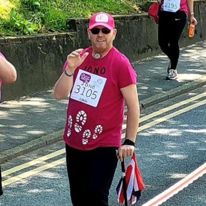 Jon taking part in the Banham Marsden March, wearing red t-shirt and cap