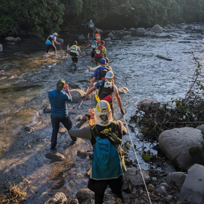Participants crossing river in Amazon jungle