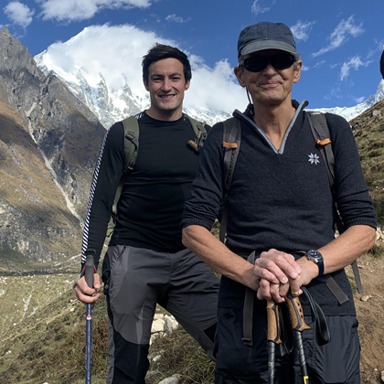 Hector with his dad Hugh on a mountain, smiling