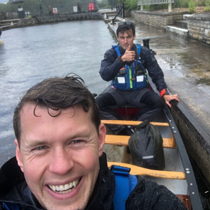 Selfie of Hector and Charlie  on a boat (Charlie at the front)