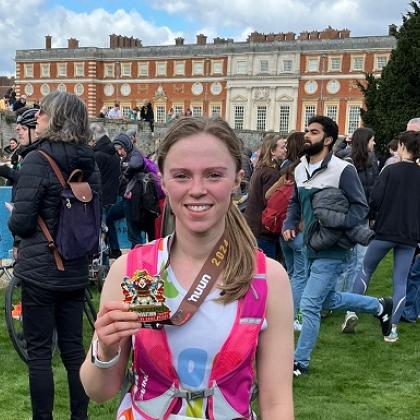 RMCC runner smiles with medal 