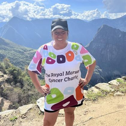 Woman standing in front of a mountain wearing a Royal Marsden Cancer Charity t-shirt