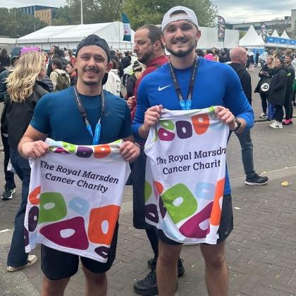 Runners holding charity running vests