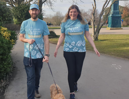 a man and a woman, fundraising and walking their dog