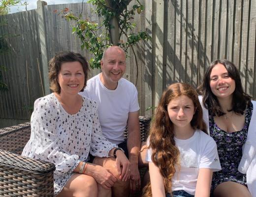 Sally sitting in the garden with her family