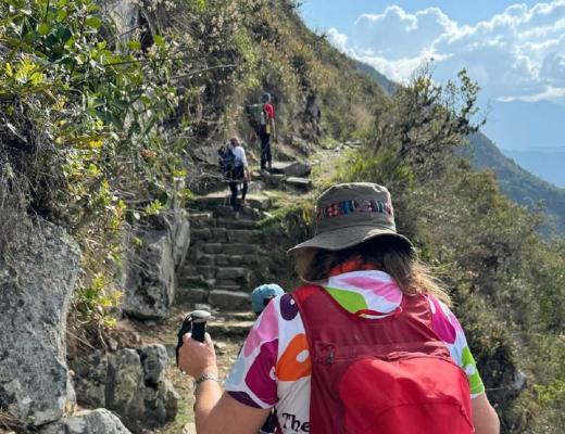 Hikers climbing mountain edge