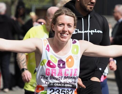 Runner in RMCC vest with arms out